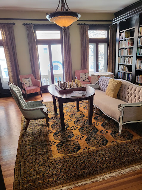 The Thames Club library with floor-to-ceiling bookshelves and fireplace